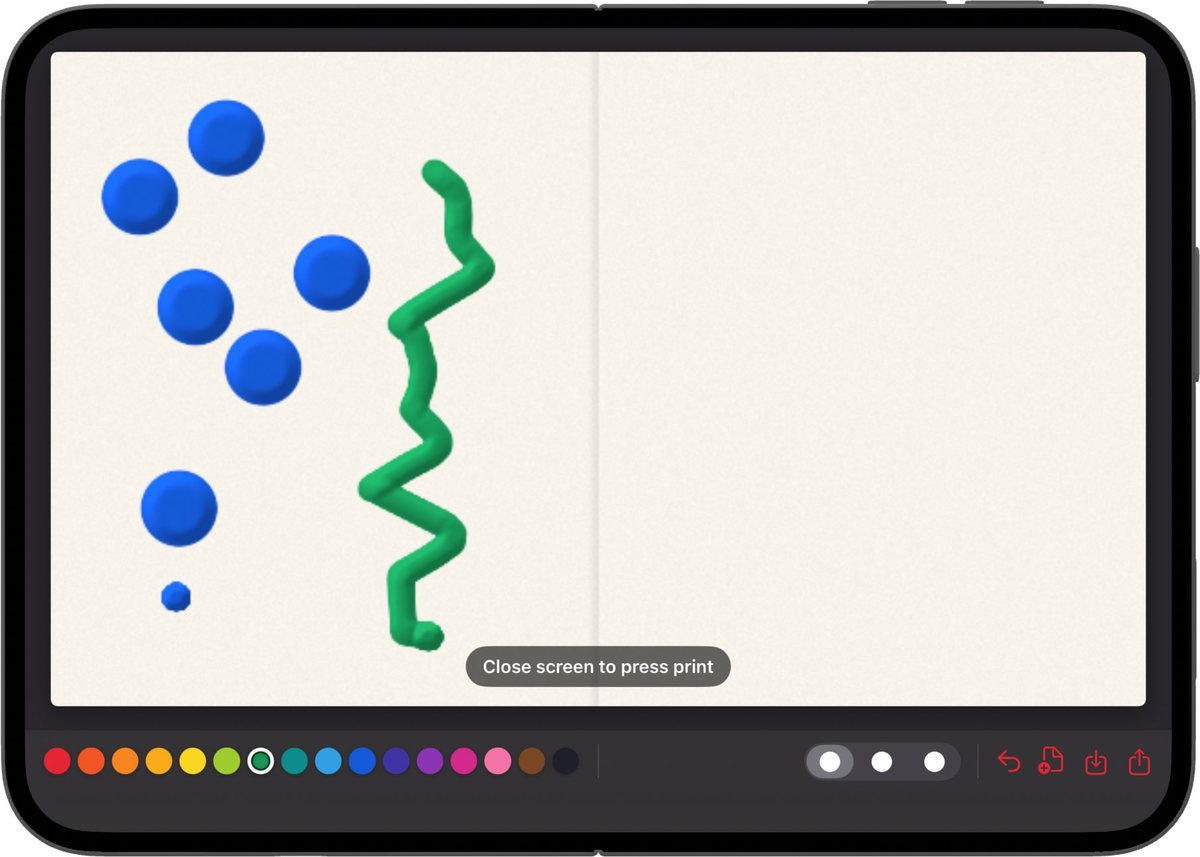 Paint & Fold open flat, with blue dots and a green zigzag painted on the left half of the screen and the right half still blank. A prompt reads: Close screen to press print.